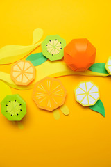 Fruit made of paper. Yellow background. Tropics.