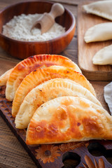 Homemade pasties on a wooden board, selective focus
