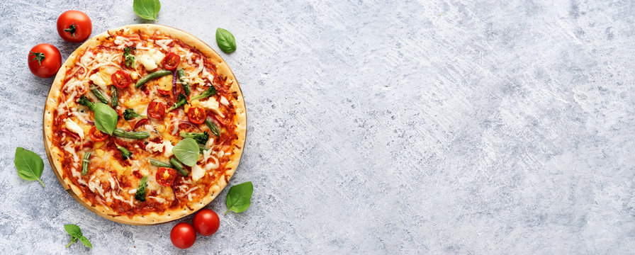 Fresh vegetarian pizza on light blue background