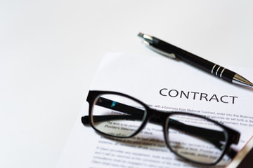 Fototapeta premium White table with business document contract form paper and empty space to sign authorized signature, copy space available for text