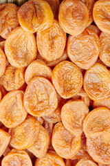 Background from appetizing dried apricots close-up