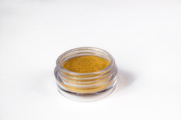 Gold eye shadows  isolated on white background. Concept of makeup and beauty.