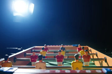 Foosball table soccer. Sport team football players