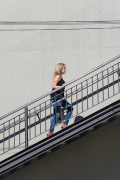 Blonde Woman Walking Up Stairs Outdoor In The City