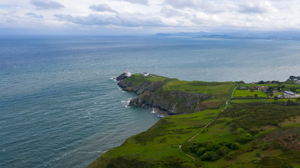 Naklejka premium Beautiful view of Valentia Island Lighthouse at Cromwell Point. Scenic Irish countyside on sunny summer day, County Kerry, Ireland.