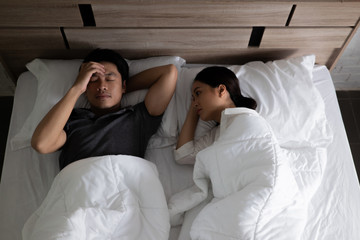 Naklejka na ściany i meble Asian couples are very stressed. they are in bed thinking