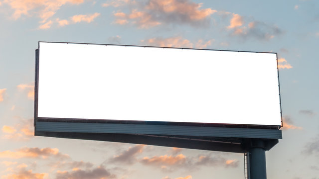 Mock up image: wide blank white billboard or large display and clouds against sunset warm sky. Consumerism, mockup, advertising, isolated white screen, background, template, copyspace concept