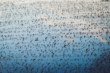 Rain drops on car window glasses natural pattern of raindrops background
