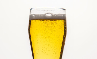  light filtered beer with a transparent glass on a white background with bubbles