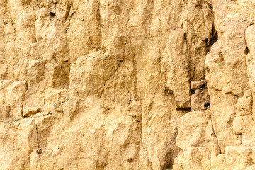 sandstone and clay wall covered with erosion and cracks