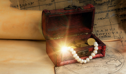 pirate chest on vintage maps and scrolls  with sparkling treasure