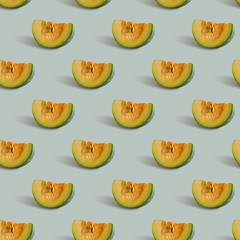 Seamless pattern with pumpkin slice on a gray-green background