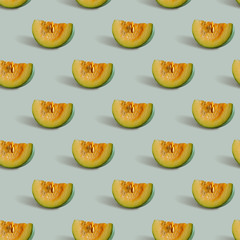 Seamless pattern with pumpkin slice on a gray-green background