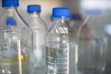 Bottles of chemicals on the table in the lab. Scientific research.