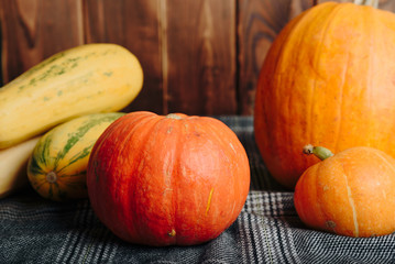 autumn set of pumpkins and dried leaves on a wooden background