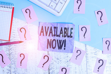 Text sign showing Available Now. Business photo showcasing you can find it obtain or operable at this current moment Writing tools, computer stuff and math book sheet on top of wooden table