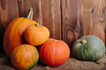 autumn set of pumpkins and dried leaves on a wooden background