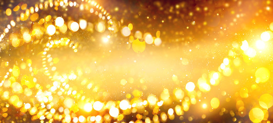 Golden Christmas and New Year glittering stars swirl on black bokeh background, backdrop with...