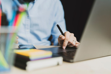 Office worker sitting at laptop and working on projects. Homebased jobs. Person getting distant online education via internet.