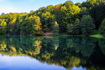 Beautiful turquoise lake surrounded by green forest and mountains. Balkana lake in Bosnia and Herzegovina.