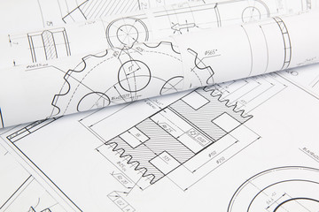 paper engineering drawings of industrial parts and mechanisms