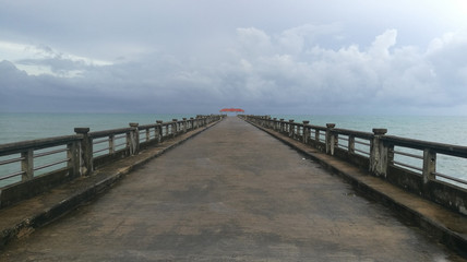 Pier with sea, sky and cloud at Natai beach, Phang-nga provience, Thailand. Quite, peaceful and beautiful place.
