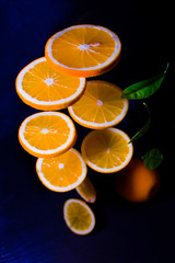 Flying orange. Sliced orange isolated on black background. Levity fruit floating in the air