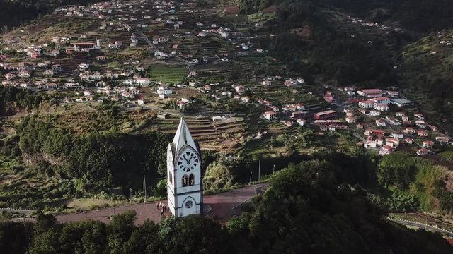 Flying around of "Nossa Senhora de Fatima" old chapel tower in "Sao Vicente", Madeira island, Portugal.