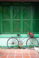 old bicycle at green window.