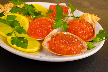 red caviar and seafood with lemon and herbs, seafood dish, delicacy. close-up, selective focus