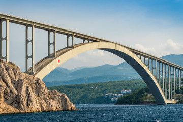 Bridge to the island Krk under blue sky on a sunny summer day. Krk is the big island of the Croatian coast of the Adriatic Sea. Travel landscape
