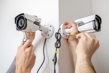 Technician worker installing video CCTV camera