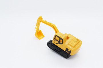 Yellow toy tractor isolated on white background.