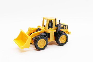 Obraz na płótnie Canvas Yellow toy tractor isolated on white background.