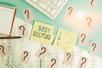 Text sign showing Body Sculpting. Business photo text activity of increasing the body s is visible muscle tone Writing tools, computer stuff and math book sheet on top of wooden table