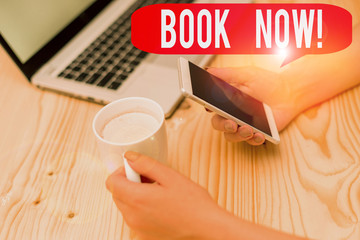 Text sign showing Book Now. Business photo text guaranteed to have place because you have already purchased it woman laptop computer smartphone mug office supplies technological devices