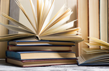 Naklejka premium Open book, hardback books on wooden table. Back to school. Copy space