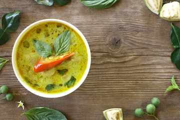 Top view of green curry fish ball (Thai food) in white bowl on wood table, look delicious. Have copy space for put text.