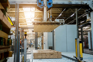 Naklejka premium Production line of the wooden floor factory. CNC automatic woodworking machine.