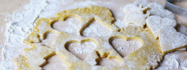 the dough for the shortbread in a heart shape on cutting Board
