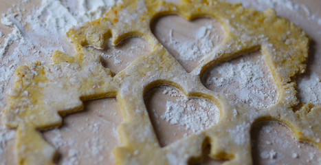 the dough for the shortbread in a heart shape on cutting Board