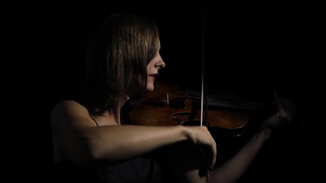 Violinist plays in darkness