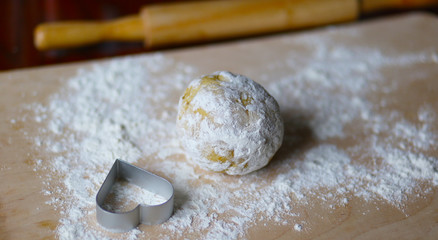 the dough for the shortbread in a heart shape on cutting Board