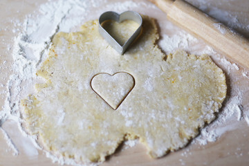 the dough for the shortbread in a heart shape on cutting Board