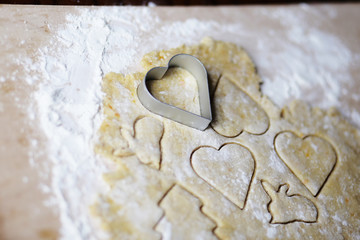 the dough for the shortbread in a heart shape on cutting Board