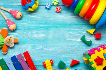Colorful kids toys frame on wooden background. Top view. Flat lay. Copy space for text. - 295671130