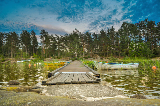  Peaceful cloud landscape on wooden pathway through the lake water and water reflection of stadinding cannoe during the sunset