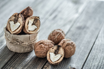 Walnut in open form on a wooden background, close-up .