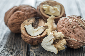 Fototapeta premium Walnut in open form on a wooden background, close-up .