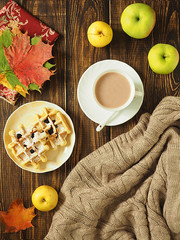 Autumn. flat lay. Sheets, a warm scarf, a Cup of tea and apples with pen on wooden rustic background.